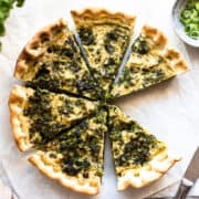 Vegan spinach quiche cut into slices.