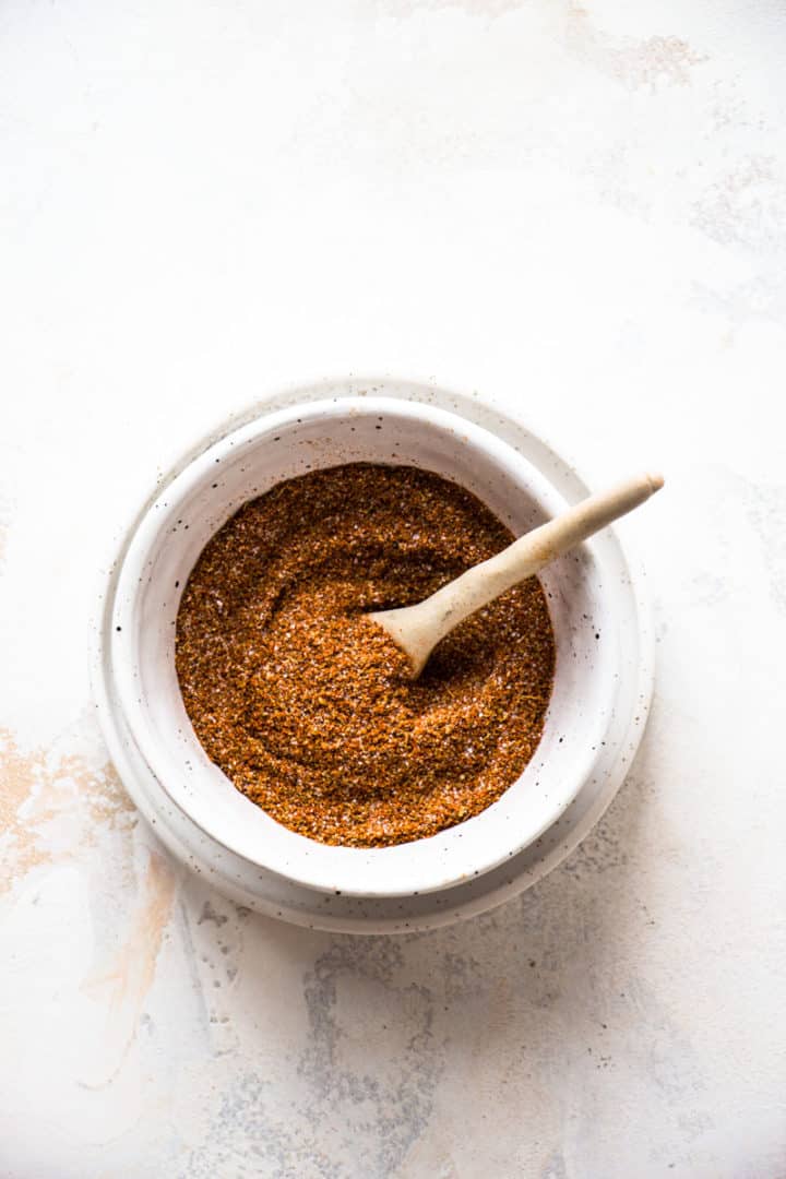 Gluten-free chili seasoning in a small speckled white bowl.