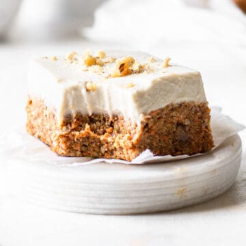 Square piece of no-bake carrot cake on white parchment paper.
