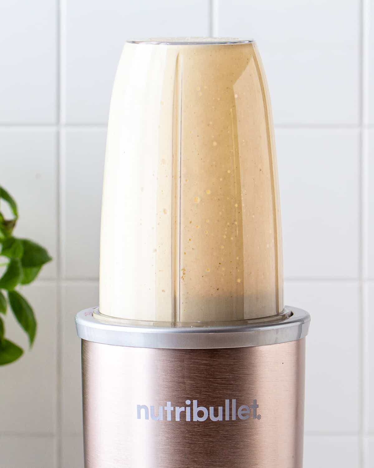 Blended caesar dressing in a Nutribullet personal blender.