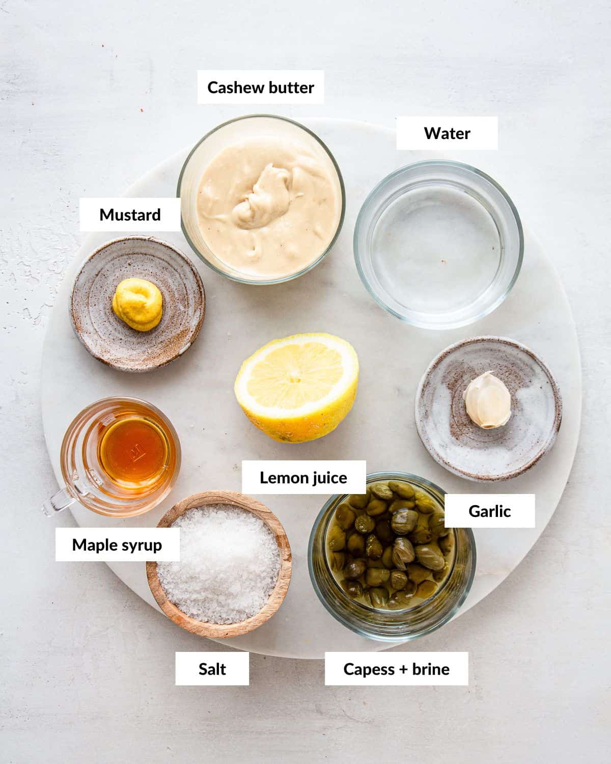 Ingredients for a caesar salad dressing with descriptive labels.
