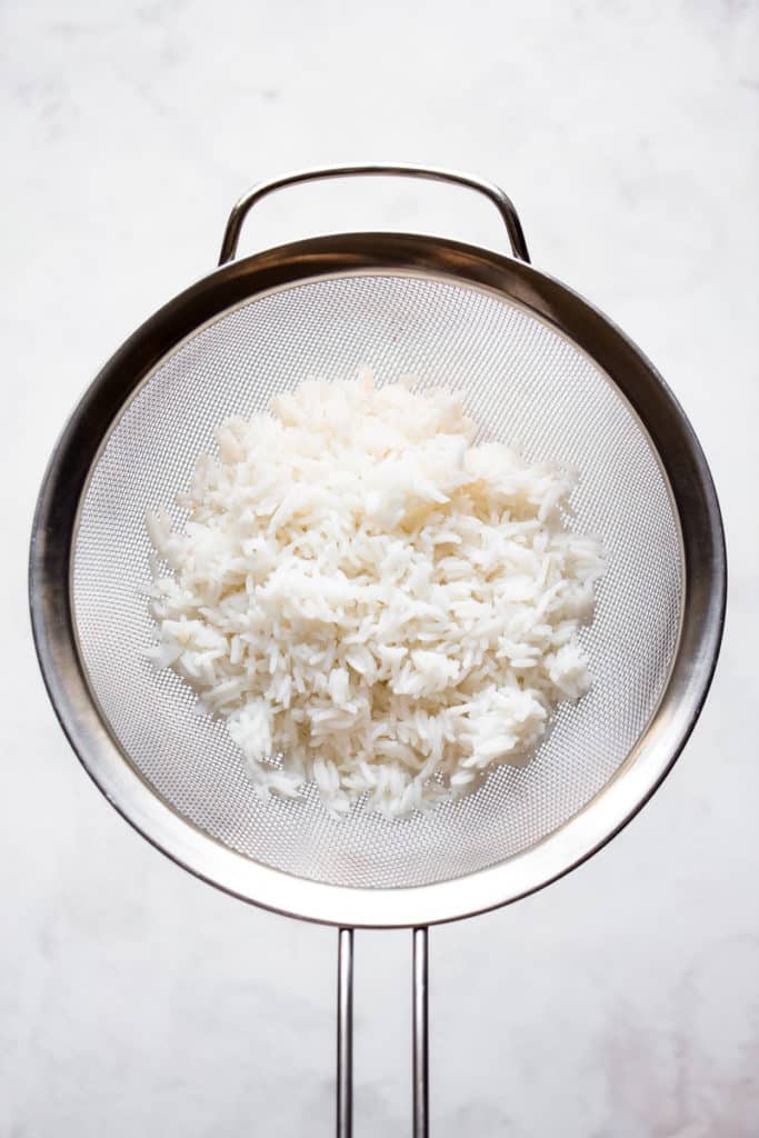 Cooked rice in a sieve