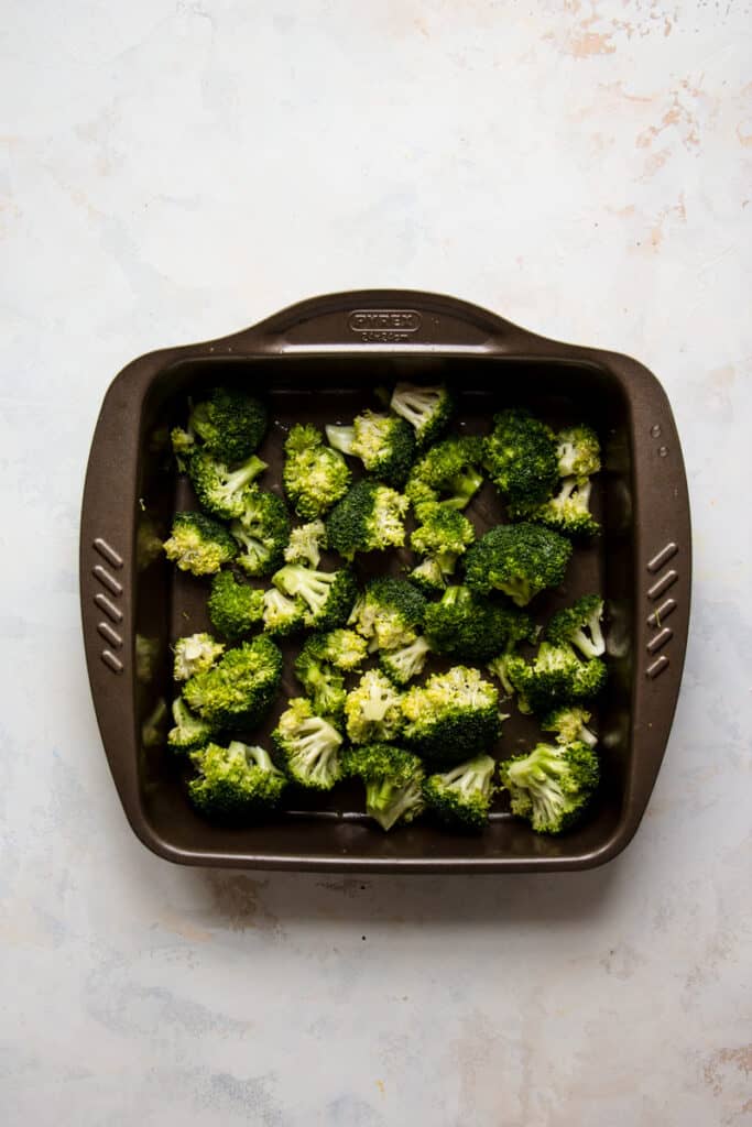 Raw broccoli in a baking dish.