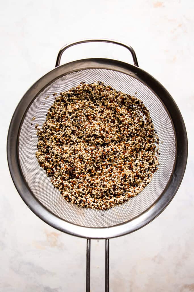 Rinsed quinoa in a fine-mesh sieve.