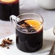 Non alcoholic mulled wine in a glass mug.