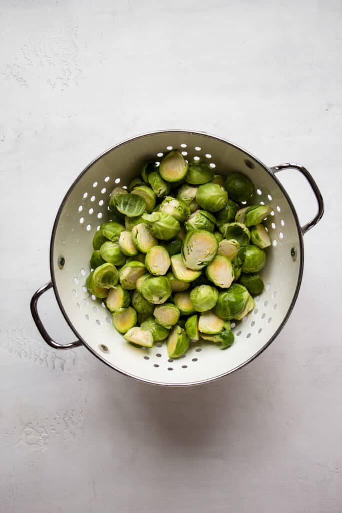 Washed Brussels sprouts in a colander.