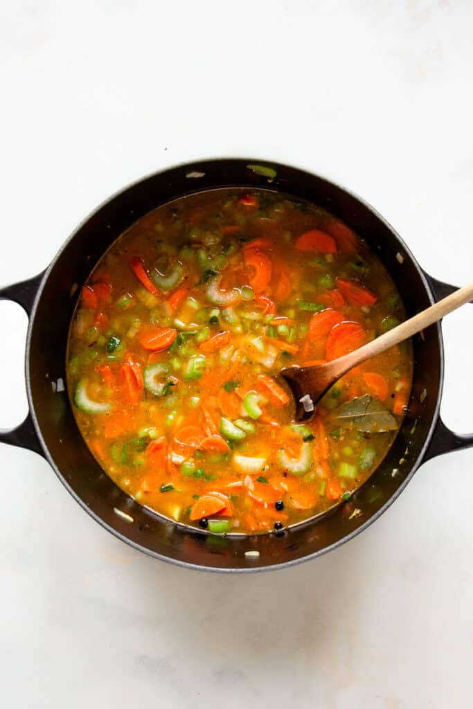 Vegetables and vegetable broth in a pot.