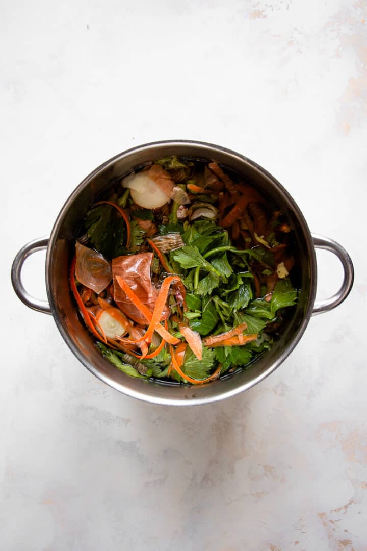 Stockpot filled with vegetable scraps and water.