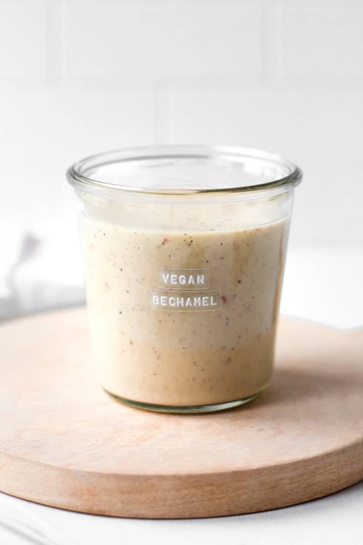 Glass jar filled with vegan bechamel sauce.