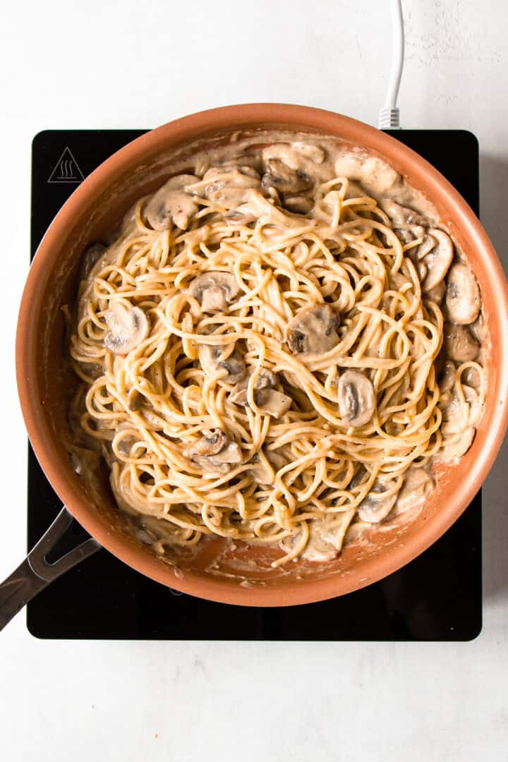 Spaghetti tossed in the pan with the mushroom sauce.