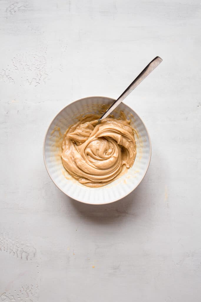 Cashew butter mixture in a medium bowl with a spoon.