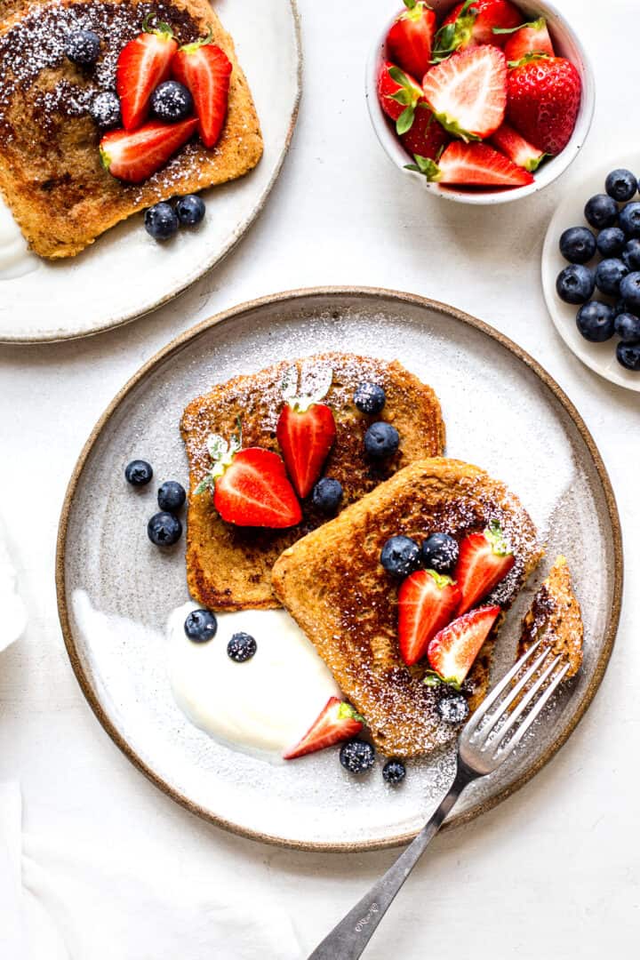 Protein french toast served with plant-based yogurt, strawberries and blueberries.