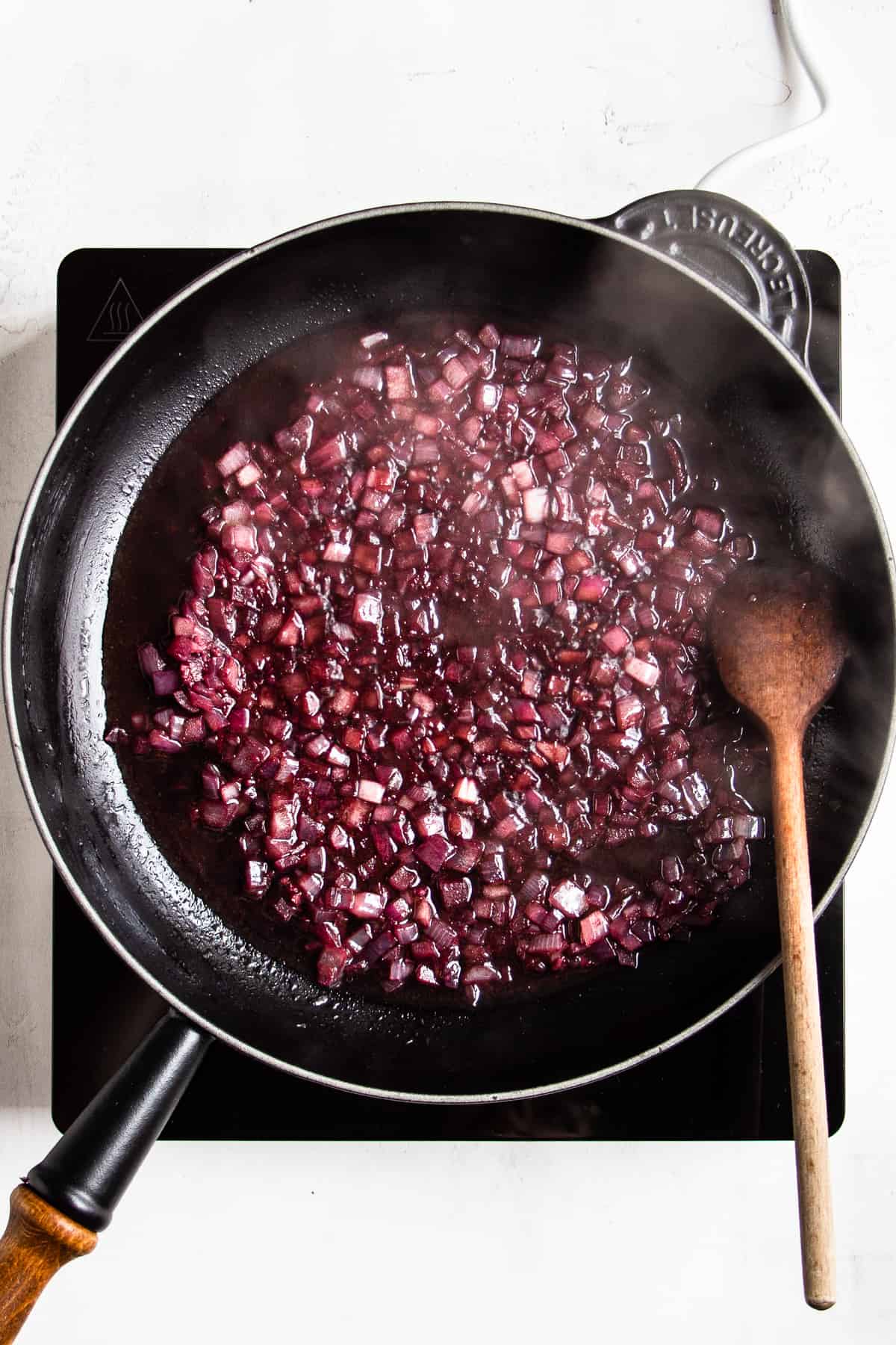Diced onion cooked in red wine.