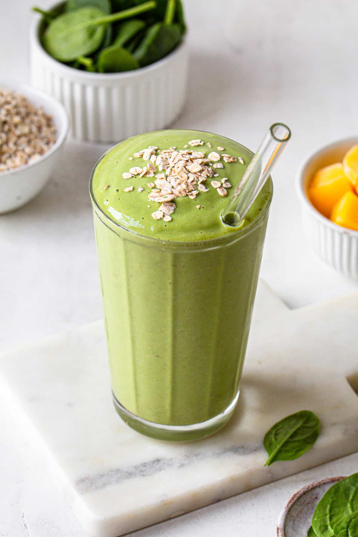 Green smoothie topped with oats.