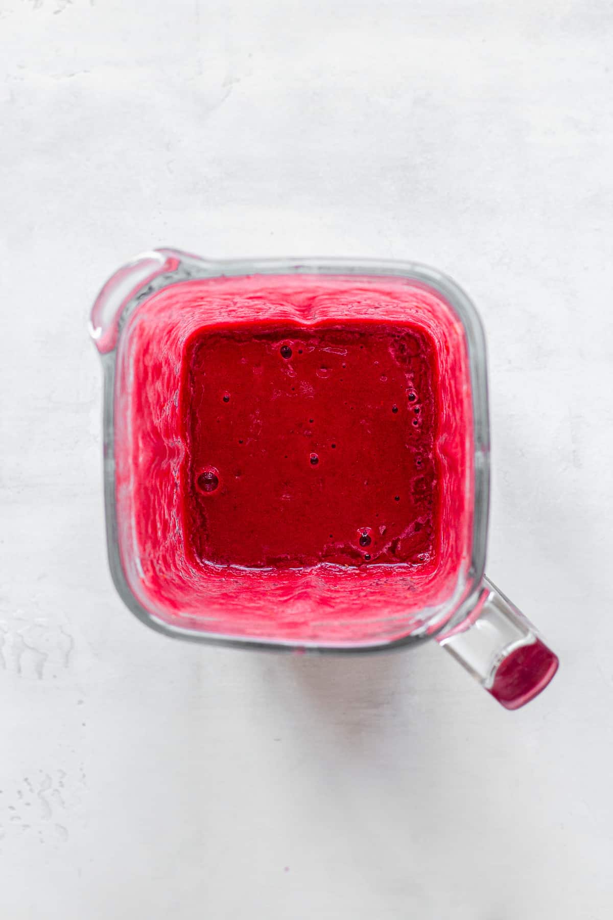 Top view of a blended pink cranberry and beetroot smoothie.