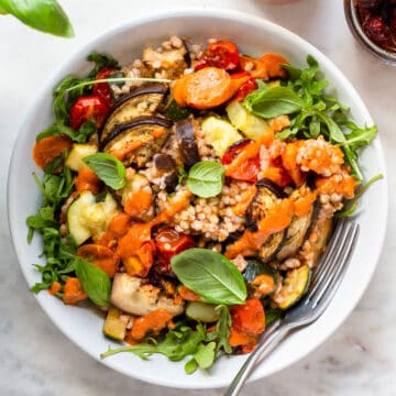 Buckwheat salad with roasted vegetables topped with an orange sun-dried tomato dressing.