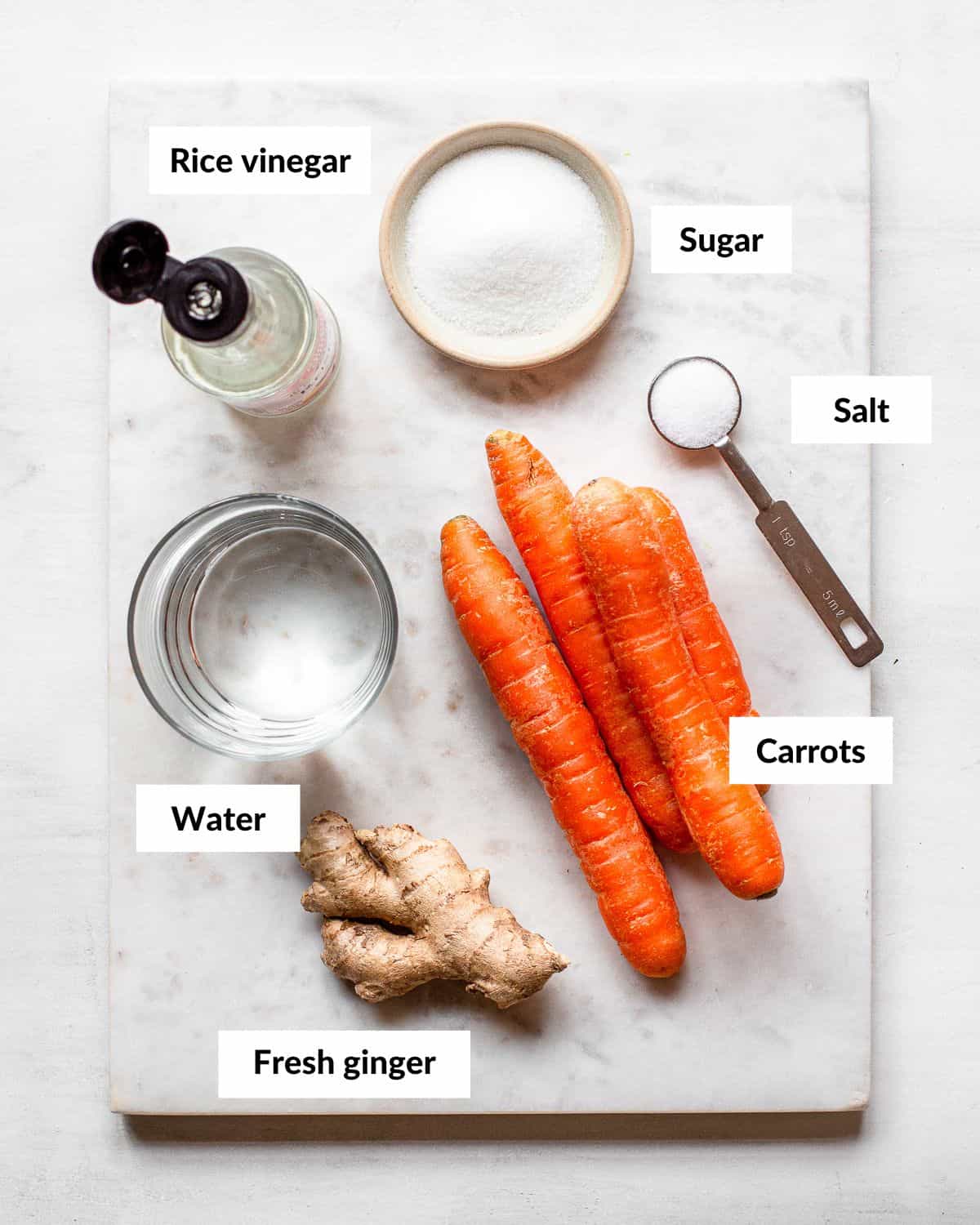 Ingredients for ginger pickled carrots with descriptive labels.