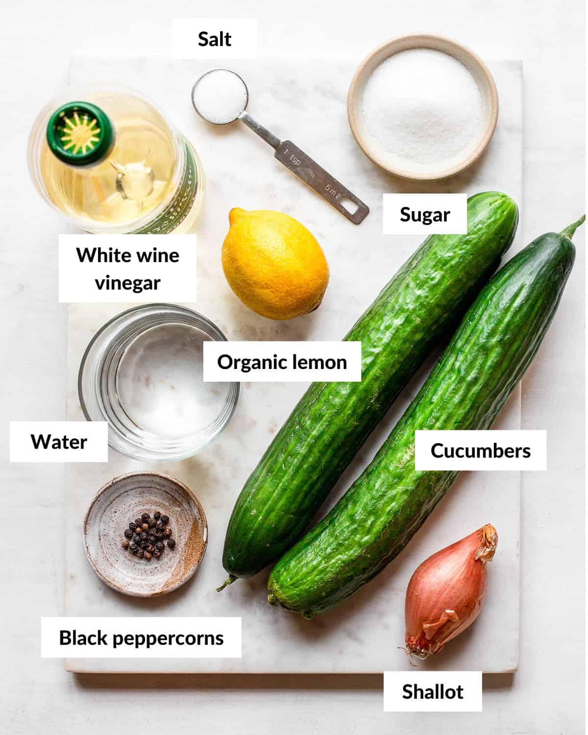 Ingredients for pickled cucumber salad with descriptive labels.