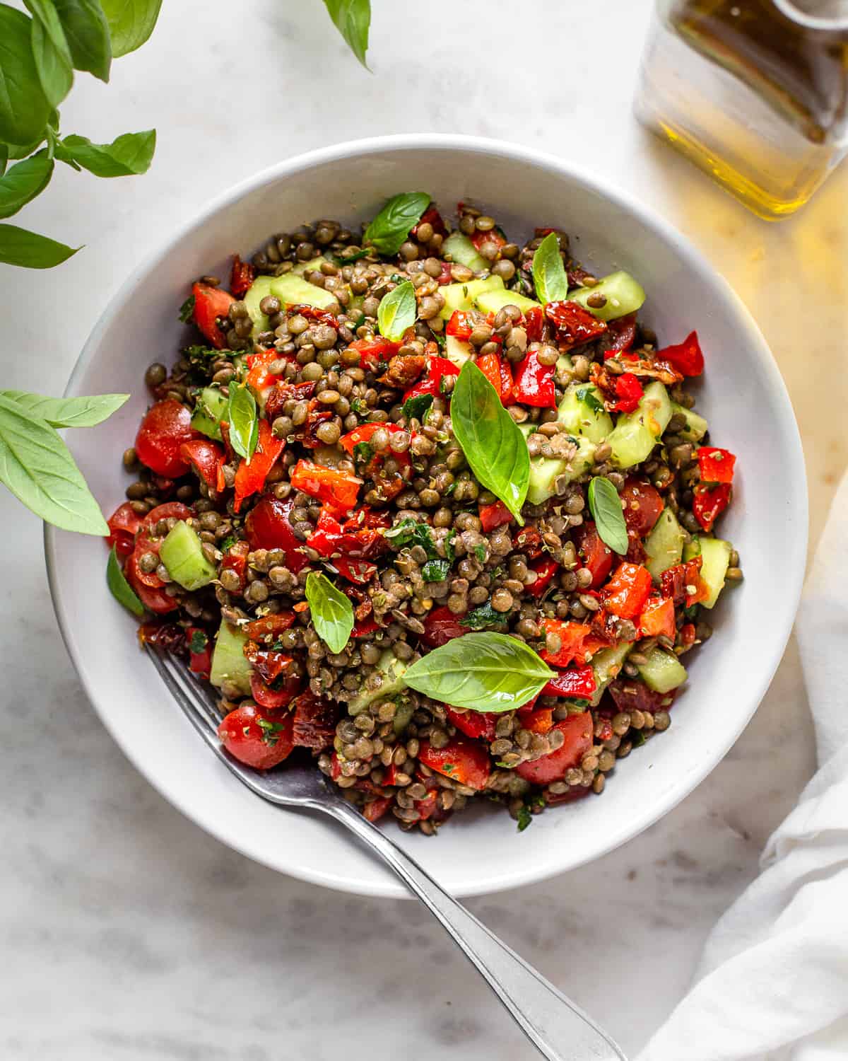 Puy lentil salad with cucumber, cherry tomatoes, fresh basil, sun-dried tomatoes, and roasted peppers.