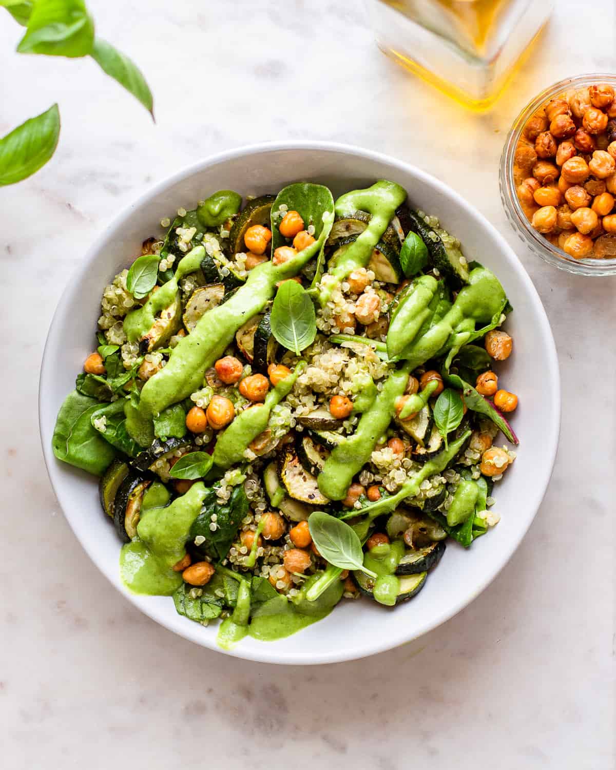 Zucchini salad with roasted chickpeas and quinoa topped with a bright green dressing.