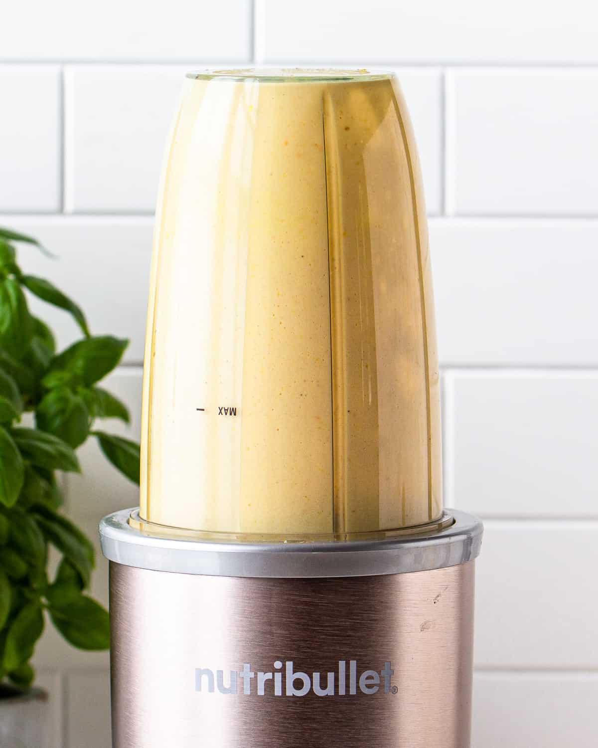 Yellow dressing in a Nutribullet personal blender.