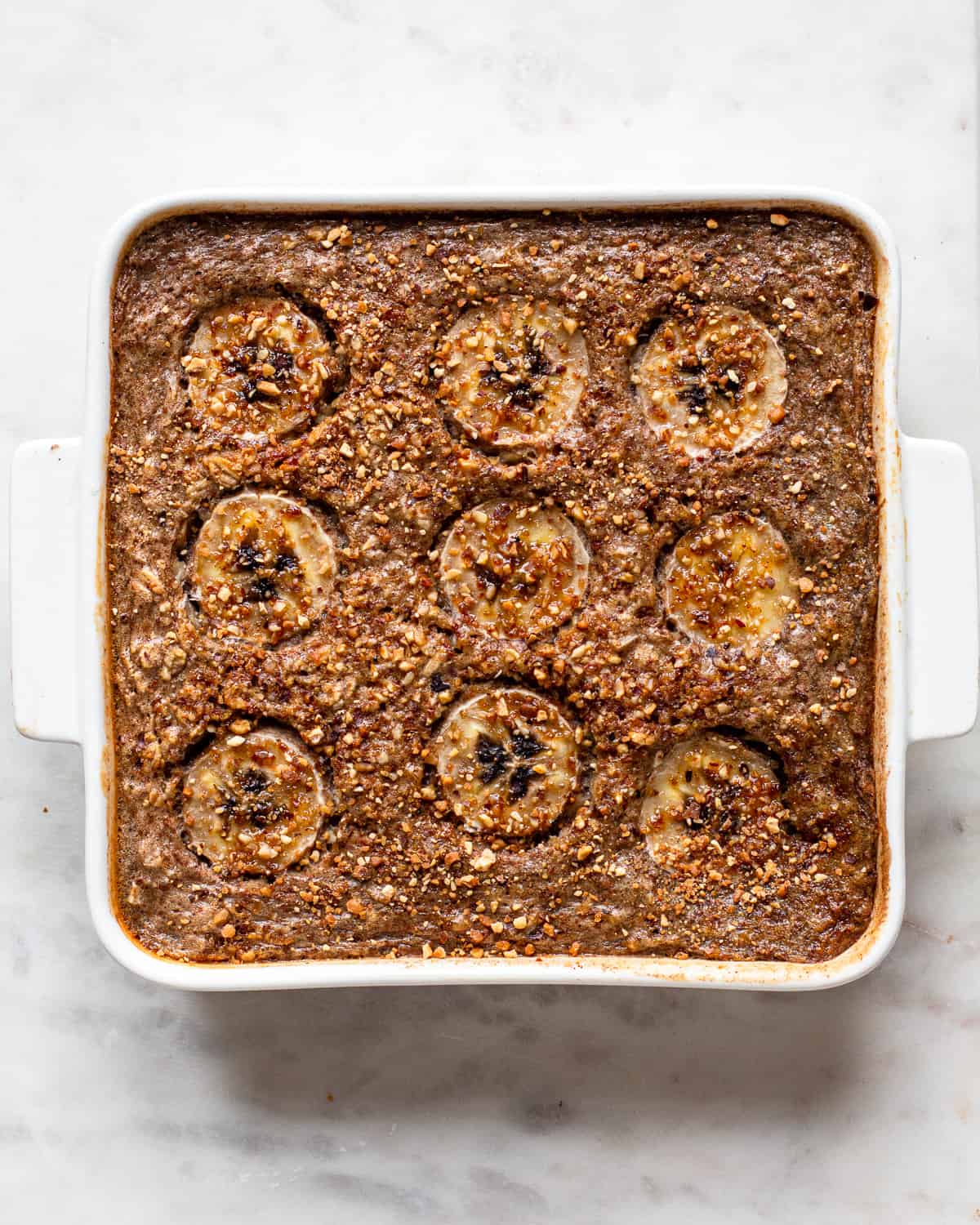 Baked oatmeal topped with banana slices.