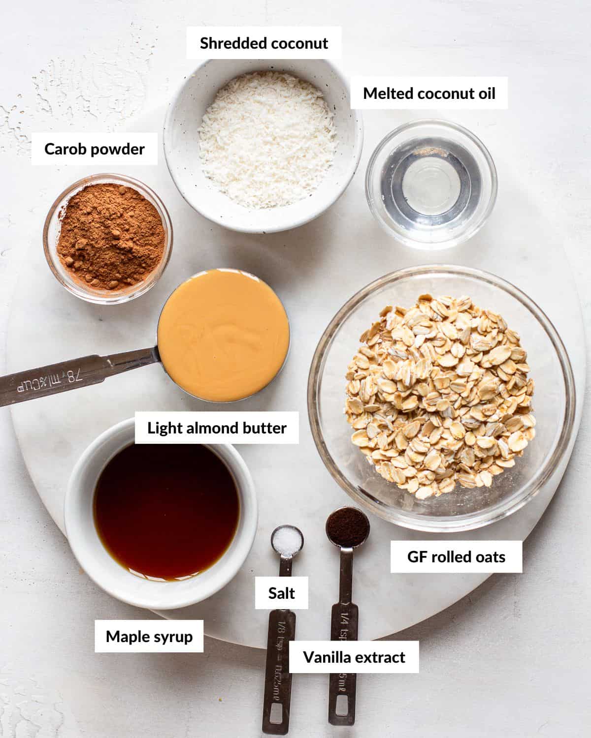 Ingredients for carob energy balls with descriptive labels.