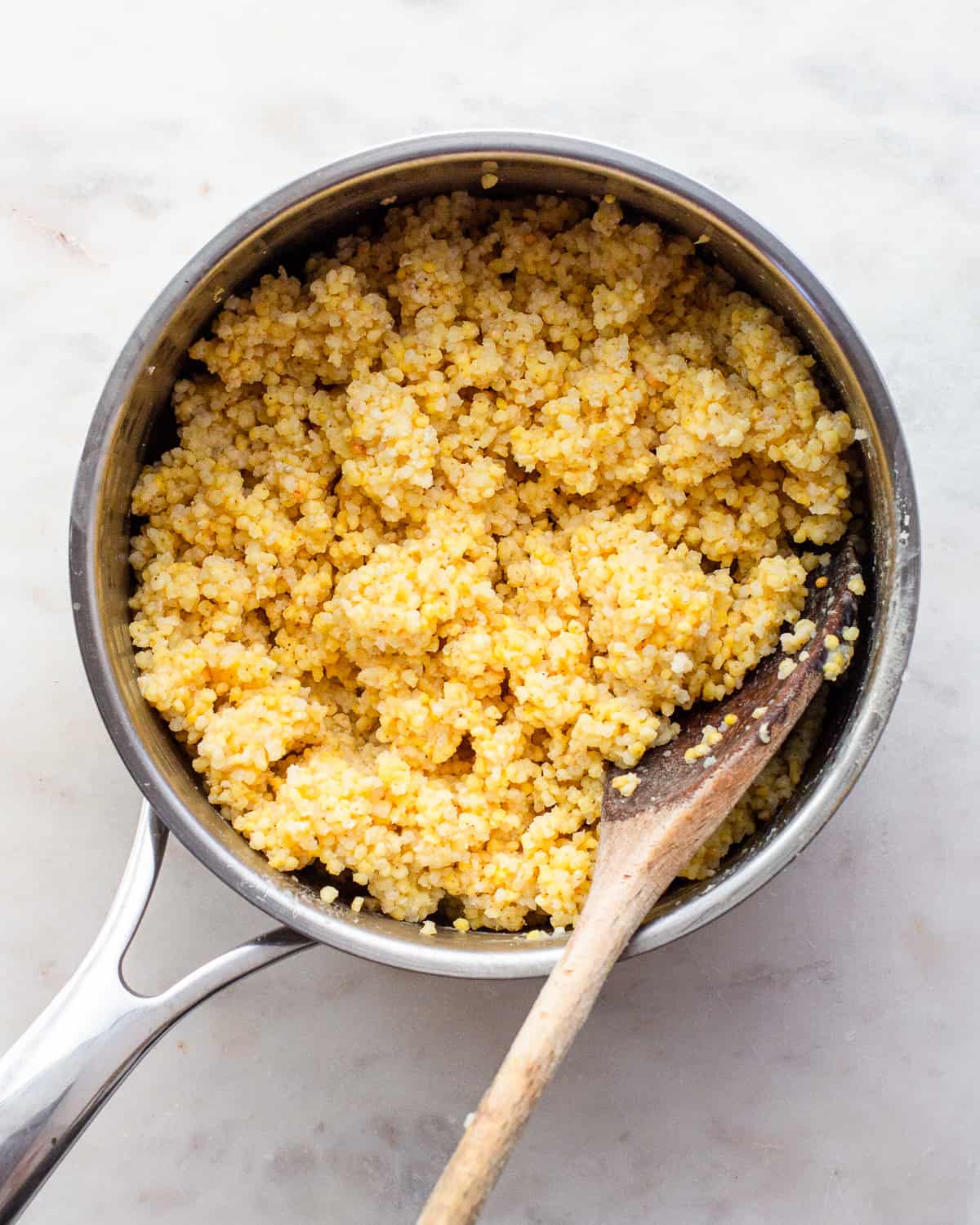 Cooked millet in a small pot.