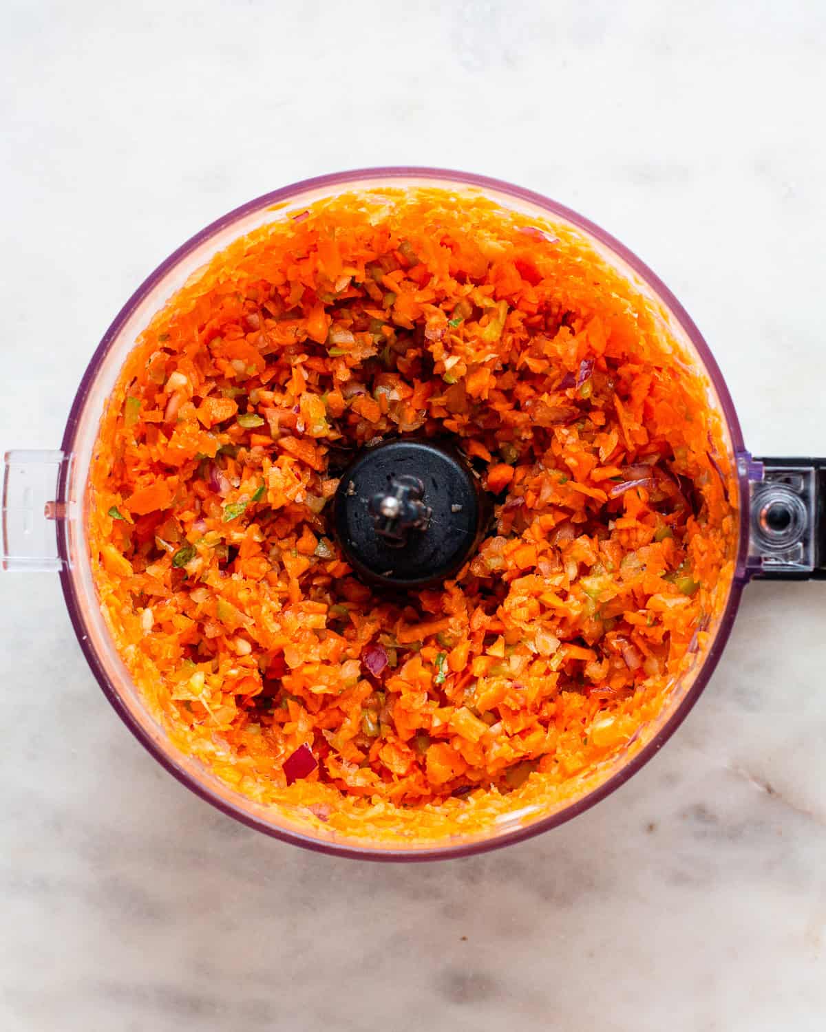 Finely chopped carrots, celery, and onion in a food processor.